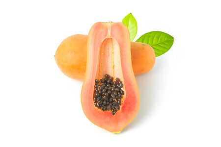 Whole and half of ripe papaya fruit with seeds on white backgroundの写真素材