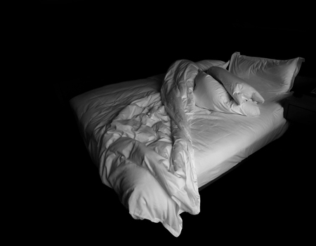 View of an unmade bedの写真素材