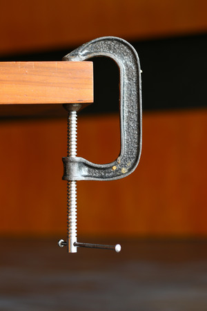 C Clamp at the edge of a tableの写真素材