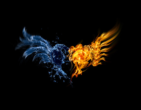 Burning heart. Heart in fire and water isolated on black backgroundの写真素材