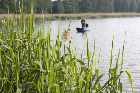 View of anglers fishing on the boatの写真素材