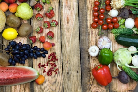 Various vegetables and fruits on wooden backgroundの写真素材