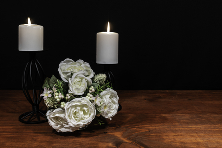 Beautiful bouquet of arranged flowers white candles on a holder on a wooden table. mothers day, Easter, valentines, birthday, Christmas,の写真素材
