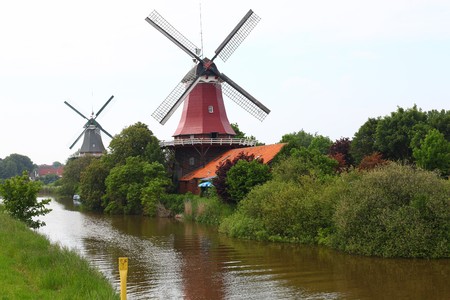 Twin windmill - The windmills are located in the north of germany in Greetsiel. This is the north sea . They have a high cultural level. It is a tourist attraction in the north of germany.の写真素材