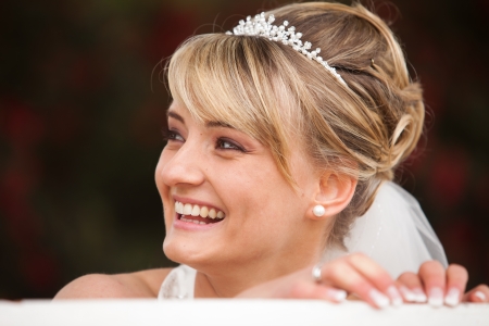 Funny laughing bride portrait  Face photo of a beautiful happy and pretty bride with diadem in her hairの写真素材