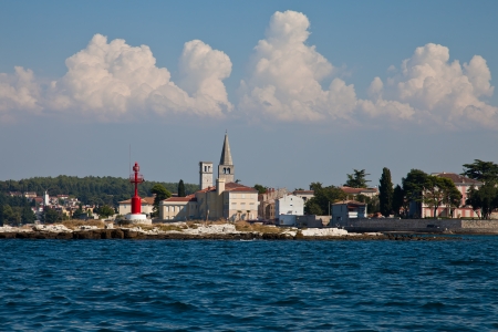 Very nice view from the sea to Porec Nice blue and cloudy sky and clear blue water  Beacon beside the churchの写真素材