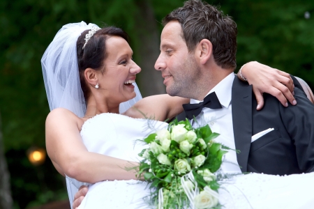 Groom is carrying his bride on hands の写真素材