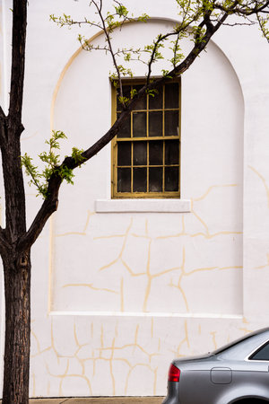 Flagstaff, Arizona USA - May 23, 2019: Tree and car juxtaposed with a beautiful building, arch and...
