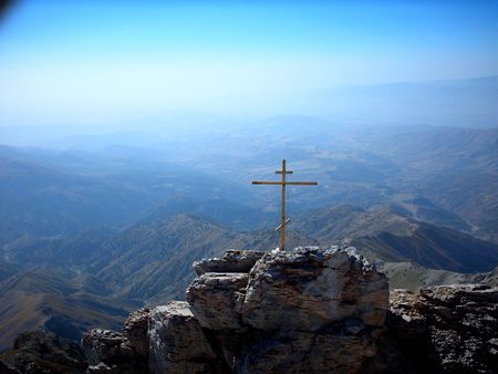 Orthodoxy cross on the Chimgan mount on the mountain country background. Chimgan region, Uzbekistanの写真素材