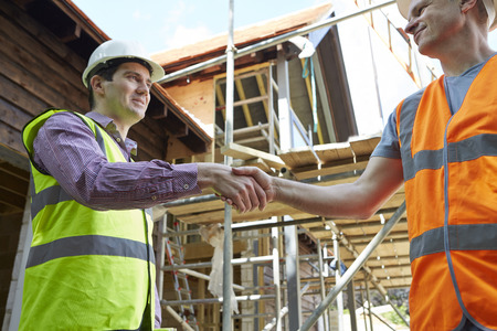 Architect Shaking Hands With With Builderの写真素材