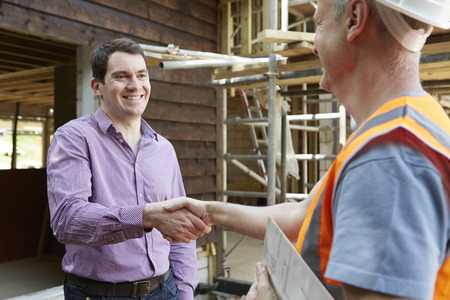 Customer Shaking Hands With Builderの写真素材