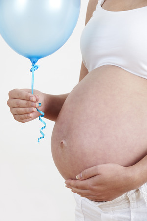 Close Up Of Pregnant Woman Holding Blue Balloonの写真素材