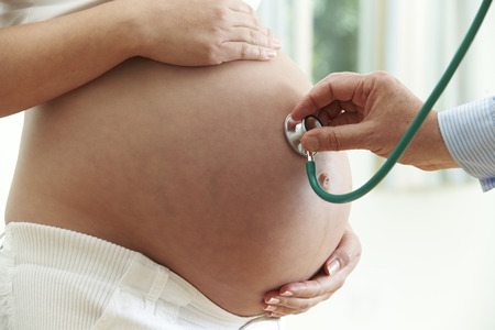 Doctor Giving Health Check To Pregnant Womanの写真素材