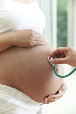 Doctor Giving Health Check To Pregnant Womanの写真素材