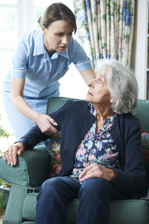 Care Worker Mistreating Senior Womanの写真素材