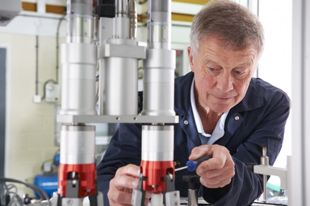 Engineer Working On Machine In Factoryの写真素材
