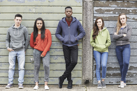 Gang Of Teenagers Hanging Out In Urban Environment