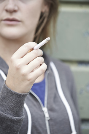 Close Up Of Teenage Girl Smoking Cigaretteの写真素材