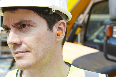 Construction Worker Wearing Protective Ear Plugsの写真素材