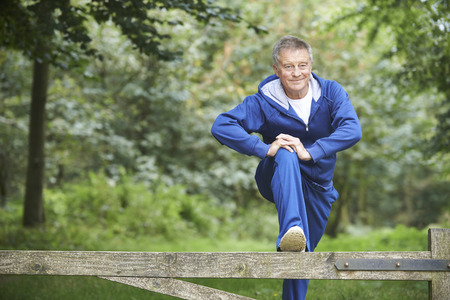 Senior Man Stretching On Countryside Runの写真素材