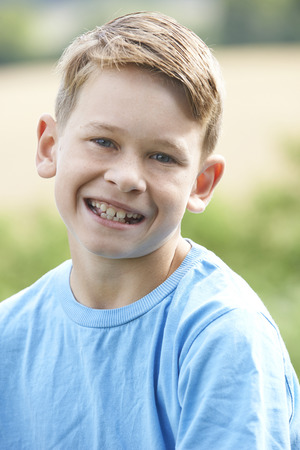 Outdoor Head And Shoulder Portrait Of Smiling Boyの写真素材