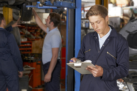 Apprentice Mechanic Working In Auto Repair Shopの写真素材