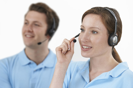 Staff Answering Calls In Customer Service Departmentの写真素材