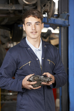 Portrait Of Apprentice Mechanic In Auto Repair Shopの写真素材