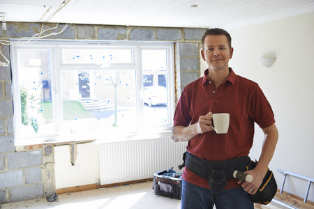 Builder Carrying Out Home Improvements Taking A Breakの写真素材