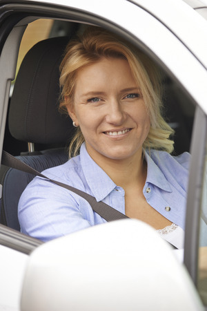 Portrait Of Female Driver Looking Out Of Car Window