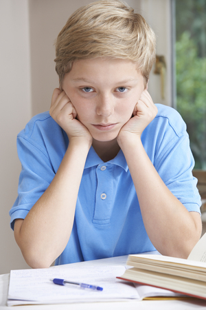 Portrait Of Boy Struggling With Homeworkの写真素材