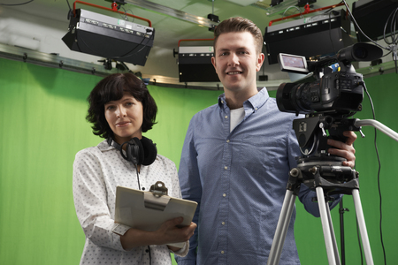 Portrait Of Cameraman And Floor Manager In Television Studio