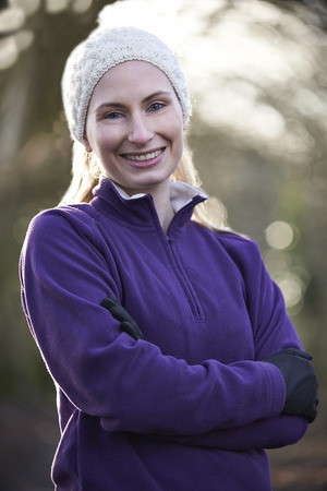 Portrait Of Woman On Winter Run Through Woodlandの写真素材