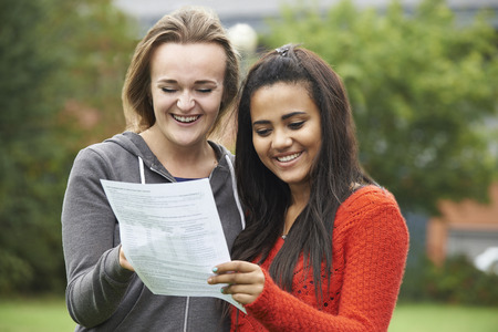 Two Female Students Celebrating Exam Results Togetherの写真素材