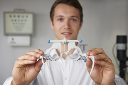 Male Optician Giving Patient Sight Test