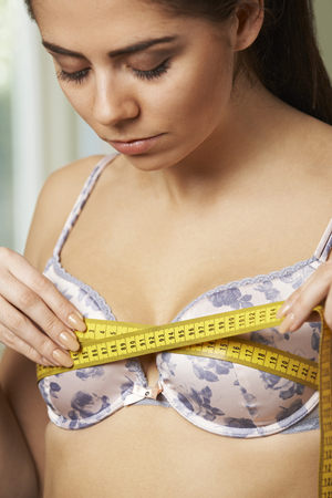 Woman Measuring Her Bra Size With Tape Measureの写真素材