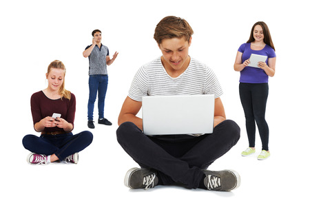 Studio Shot Of Teenagers Using Communication Technologyの写真素材