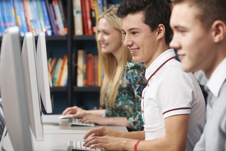 Group Of Teenage Students Working At Computers In Classroomの写真素材