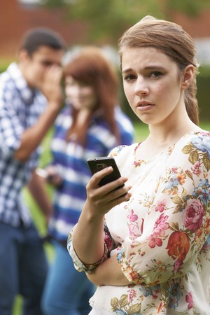 Teenage Girl Victim Of Bullying By Texts On Mobile Phoneの写真素材