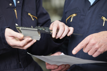 Close Up Of Engineers Measuring Component With Micrometerの写真素材