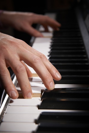 Close Up Of Hands Playing Electric Piano Keyboard