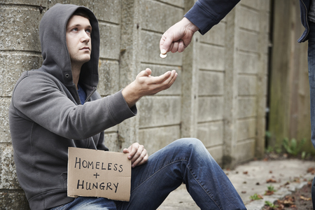 Man Giving Money To Beggar On Street