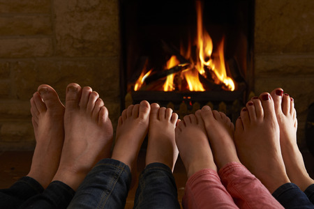 Family Warming Feet By Fireの写真素材