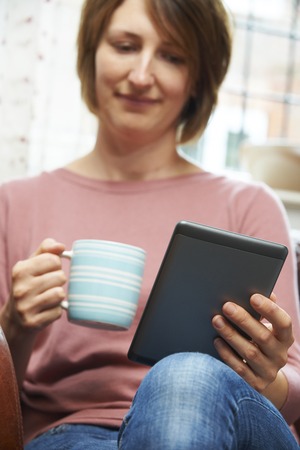 Woman At Home Reading E-Book