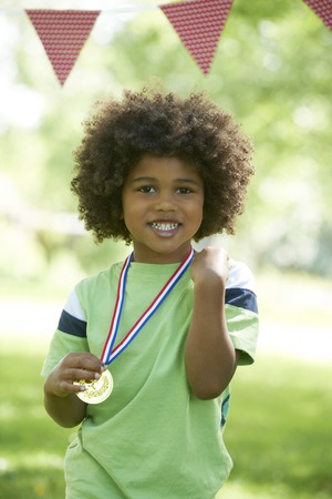 Young Boy Winning Medal At Sports Dayの写真素材