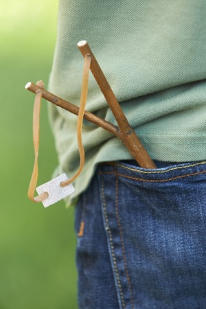 Close Up Of Slingshot In Boy's Pocketの写真素材