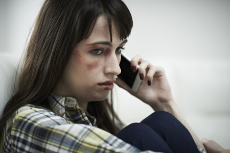 Female Victim Of Domestic Abuse Phoning Support Groupの写真素材