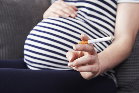 Close Up Of Pregnant Woman Smoking Cigaretteの写真素材
