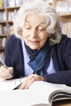 Senior Woman Studying In Libraryの写真素材