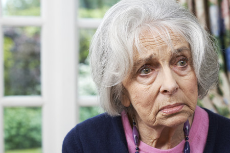 Head And Shoulders Portrait Of Unhappy Senior Woman At Homeの写真素材
